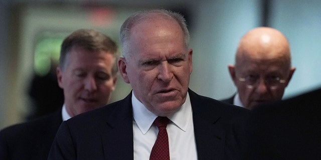 Former CIA director John Brennan, middle, and former director of National Intelligence James Clapper, right, arrive at a closed hearing before the Senate (Select) Intelligence Committee May 16, 2018 on Capitol Hill in Washington, DC. 