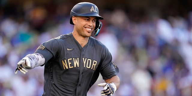 American League's Giancarlo Stanton, of the New York Yankees, points to the dugout after connecting for a two-run home run during the fourth inning of the MLB All-Star baseball game against the National League, Tuesday, July 19, 2022, in Los Angeles. 