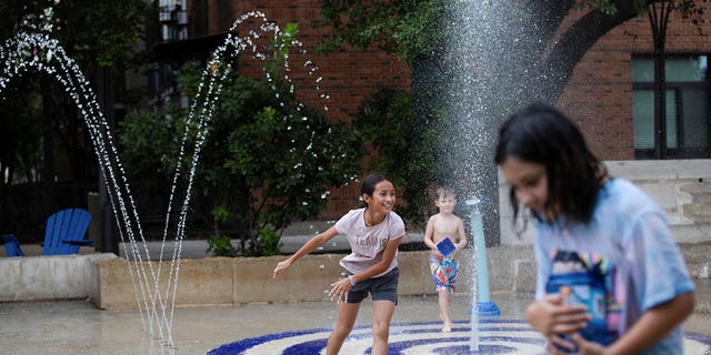 Kids play in a splash pad at Hemisfair Park as temperatures reached 93°F/34°C in San Antonio, Texas, U.S. June 28, 2022. REUTERS/Kaylee Greenlee Beal