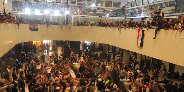 Iraqi protesters fill the parliament building in Baghdad, Iraq, Saturday, July 30, 2022.