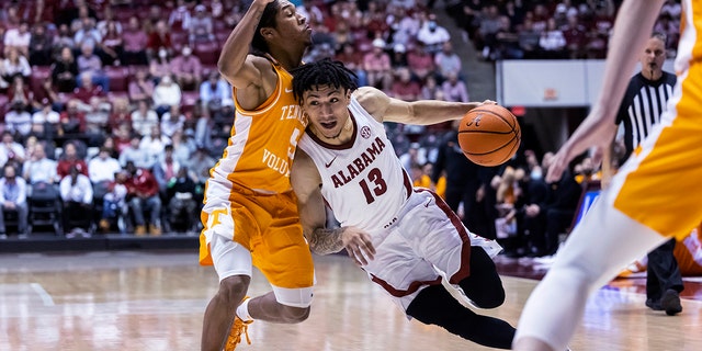 Alabama guard Jahvon Quinerly (13) works his way inside against Tennessee guard Zakai Zeigler (5) during the second half of an NCAA college basketball game Wednesday, Dec. 29, 2021, in Tuscaloosa, Ala.