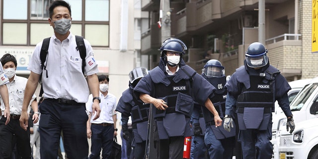 Police investigators arrive at the residence of the suspect who was believed to have shot former Japanese Prime Minister Shinzo Abe, in Nara, Japan July 8, 2022 in this photo taken by Kyodo. 