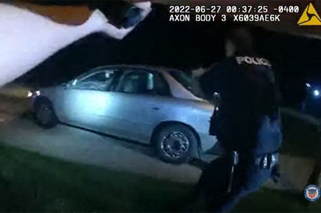 This image captured from a police officer's body camera and provided by the Akron Police Department on July 3, 2022, shows police surrounding the vehicle of 25 year old Jayland Walker during a traffic stop in Akron, Ohio, on June 27, 2022. 