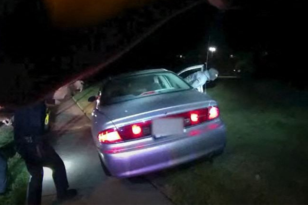 This image captured from a police officer's body camera and provided by the Akron Police Department on July 3, 2022, shows police surrounding the vehicle of 25 year old Jayland Walker during a traffic stop in Akron, Ohio, on June 27, 2022.