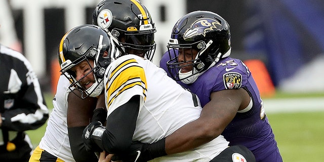 Linebacker Jaylon Ferguson (45) of the Baltimore Ravens tackles quarterback Ben Roethlisberger (7) of the Pittsburgh Steelers at M and T Bank Stadium Nov. 1, 2020, in Baltimore.