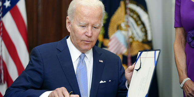 President Joe Biden signs into law S. 2938, the Bipartisan Safer Communities Act gun safety bill, in the Roosevelt Room of the White House in Washington on June 25.