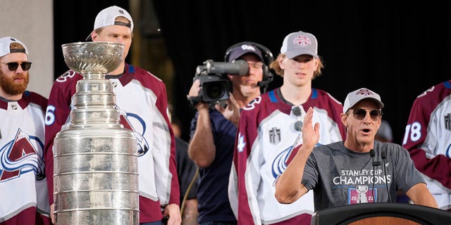 Colorado Avalanche general manager Joe Sakic, front right, speaks as the Stanley Cup sits on a nearby stand during a rally outside the City/County Building for the NHL hockey champions after a parade through the streets of downtown Denver, Thursday, June 30, 2022. 