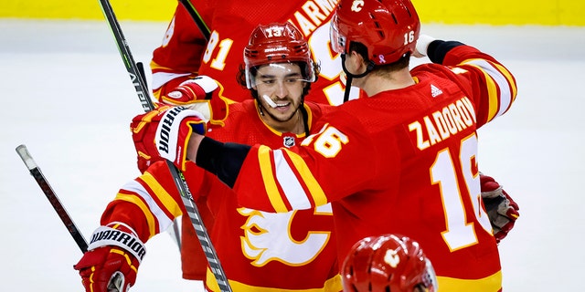 Calgary Flames forward Johnny Gaudreau, left, and defenseman Nikita Zadorov celebrates defeating the Dallas Stars in overtime NHL playoff hockey action in Calgary, Alberta, Sunday, May 15, 2022. 