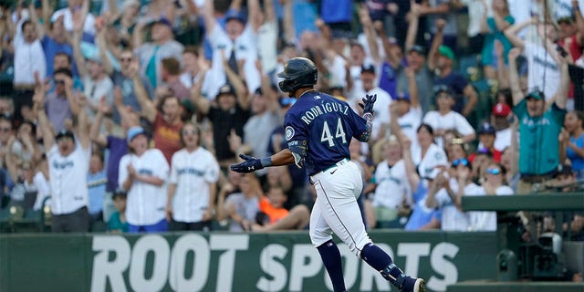 Seattle Mariners' Julio Rodriguez reacts as he rounds the bases after hitting a solo home run against the Texas Rangers during the first inning of a baseball game, Tuesday, July 26, 2022, in Seattle. 