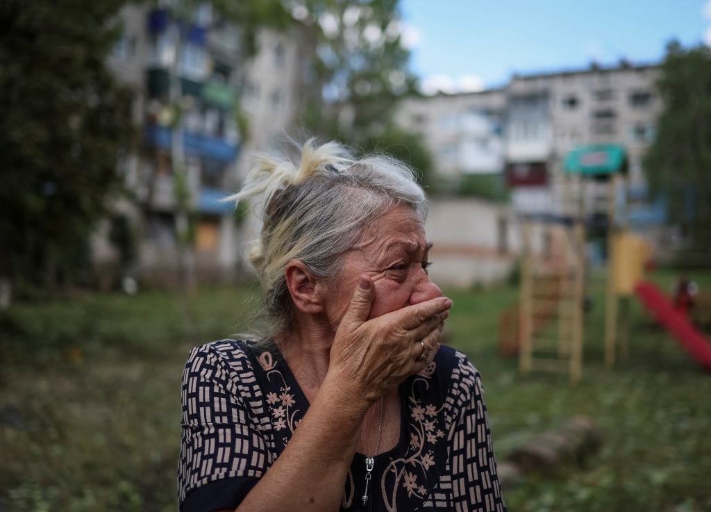 A local resident reacts after her building is damaged by a Russian military strike in Kramatorsk, Ukraine on July 19, 2022. 