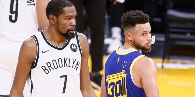 Golden State Warriors guard Stephen Curry (30) and Brooklyn Nets forward Kevin Durant (7) in the first quarter of an NBA game at Chase Center, Saturday, Feb. 13, 2021, in San Francisco, Calif. 