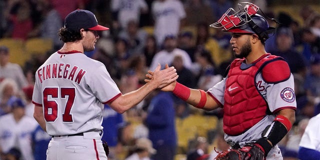 Washington Nationals relief pitcher Kyle Finnegan, left, and catcher Keibert Ruiz congratulate each other after the Nationals defeated the Los Angeles Dodgers 4-1 in a baseball game Monday, July 25, 2022, in Los Angeles. 