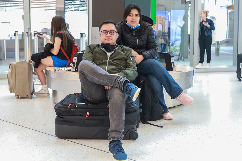 Melina Carrillo, 36 and Jose Cortes, 38, await a connecting flight to Toronto from Bogota on Saturday at Laguardia Airport in Queens. Their initial arrival for Toronto was yesterday.