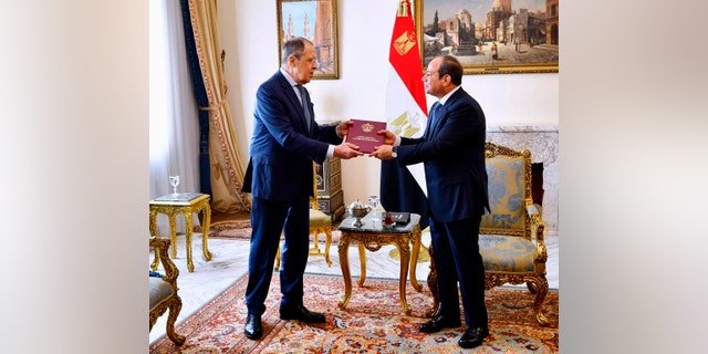 Egyptian President Abdel Fattah el-Sissi and Russian Foreign Minister Sergey Lavrov hold a document during a meeting Sunday, July 24, 2022, in Cairo, Egypt.