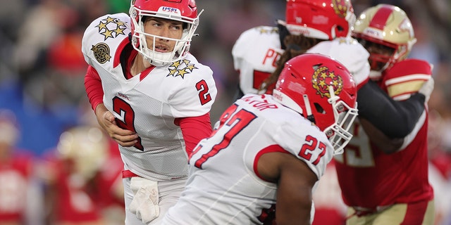 Luis Perez #2 of New Jersey Generals hands the ball off to teammate Darius Victor #27 in the first quarter of the game against the Birmingham Stallions at Protective Stadium on April 16, 2022 in Birmingham, Alabama.