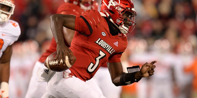 Louisville Cardinals quarterback Malik Cunningham carries the ball during the college football game between the Clemson Tigers and the Louisville Cardinals on Nov. 6, 2021, at Cardinal Stadium in Louisville, Kentucky.