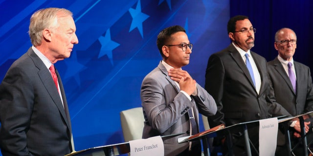 From left, Maryland Comptroller Peter Franchot, Ashwani Jain, John King and Tom Perez stand at their podiums just before a debate of eight candidates seeking the Democratic nomination for governor of Maryland June 6, 2022 in Owings Mills, Md.