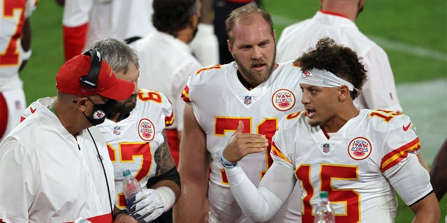 Patrick Mahomes (15) of the Kansas City Chiefs talks on the sidelines with Daniel Kilgore (67) and Mitchell Schwartz (71) during a game against the Baltimore Ravens at M and T Bank Stadium Sept. 28, 2020, in Baltimore.