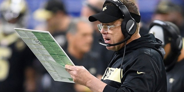 New Orleans Saints head coach Sean Payton looks over plays on the sidelines in the first half of an NFL divisional playoff football game against the Philadelphia Eagles, in New Orleans, Sunday, Jan. 13, 2019. 