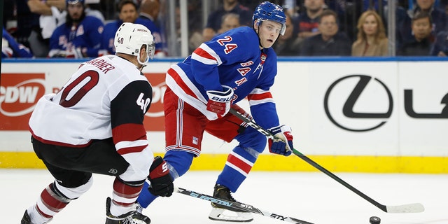 New York Rangers right wing Kaapo Kakko (24) looks to pass the puck as Arizona Coyotes right wing Michael Grabner (40) defends during the second period of an NHL hockey game Tuesday, Oct. 22, 2019, in New York. 