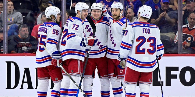 New York Rangers' Kaapo Kakko, center, celebrate his goal against the Philadelphia Flyers during the second period of an NHL hockey game, Wednesday, April 13, 2022, in Philadelphia.