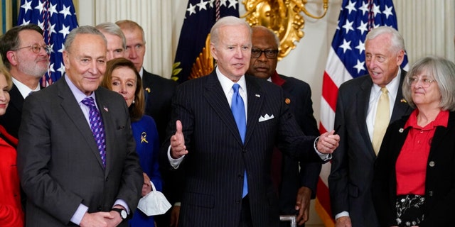 President Joe Biden gestures after signing the Postal Service Reform Act of 2022 in the State Dining Room at the White House