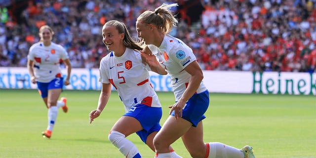 Netherlands' Stefanie van der Gragt, right, celebrates with her teammate Lynn Wilms after Switzerland's Ana-Maria Crnogorcevic scored an own goal during the Women Euro 2022 soccer match between Switzerland and Netherlands at Bramall Lane Stadium in Sheffield, England, Sunday, July 17, 2022. 