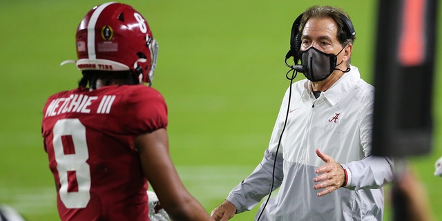 Alabama Crimson Tide head coach NIck Saban greets Alabama Crimson Tide wide receiver John Metchie III, #8, during the CFP National Championship game between the Alabama Crimson Tide and the Ohio State Buckeyes on January 11, 2021 at Hard Rock Stadium in Miami Gardens, Fl.