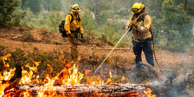 Firefighters mop up hot spots while battling the Oak Fire in the Jerseydale community of Mariposa County, Calif., on Monday, July 25, 2022. 