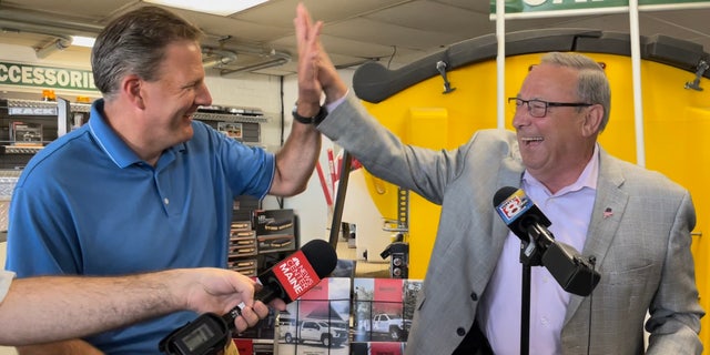 A lighter moment between Republican Gov. Chris Sununu of New Hampshire (left) and former Maine Gov. Paul LePage (right), the 2022 GOP gubernatorial nominee, at Messer Truck Equipment in Westbrook, Maine on July 13, 2022