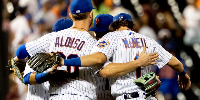 New York Mets' first baseman Pete Alonso and second baseman Jeff McNeil celebrate with teammates following their 8-5 victory against the San Diego Padres, Sunday, July 24, 2022, in New York.