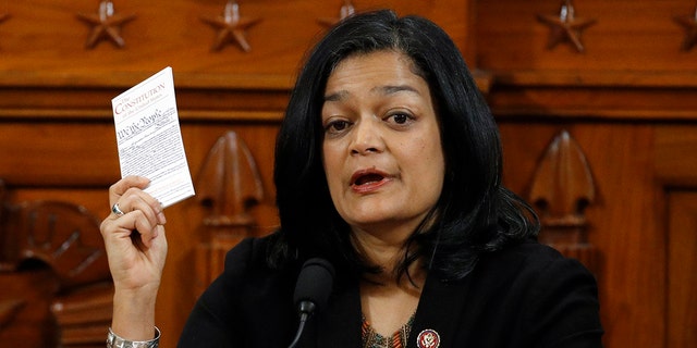 Holding up a copy of the U.S. Constitution, Rep. Pramila Jayapal, D-Wash.