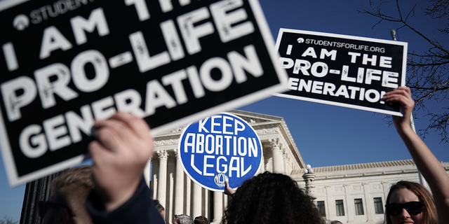 Pro-life and pro-choice activists gather on January 19, 2018 in Washington, DC.