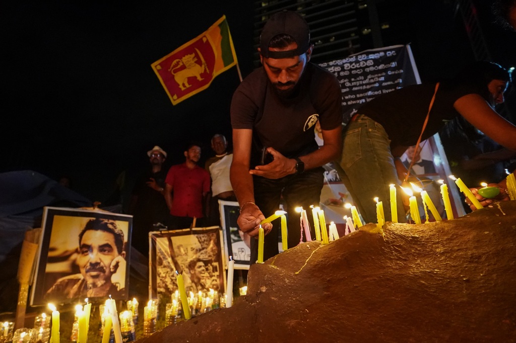 People hold a candlelight vigil for the victims and injured demonstrators during anti-government protests.