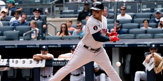 Boston Red Sox's Rafael Devers avoids a pitch during the first inning of a baseball game against the New York Yankees, Sunday, July 17, 2022, in New York.