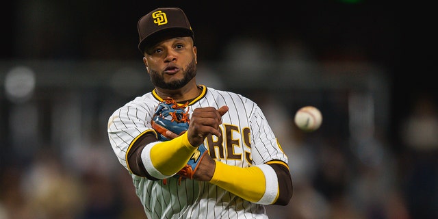 Robinson Cano #24 of the San Diego Padres fields throws to first base after fielding the ball in the seventh inning against the Milwaukee Brewers on May 23, 2022 at Petco Park in San Diego, California.