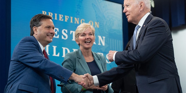 President Biden shakes hands with White House chief of staff Ron Klain alongside Secretary of Energy Jennifer Granholm on June 30, 2021. 