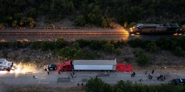 In this aerial view, members of law enforcement investigate a tractor trailer on June 27, 2022, in San Antonio, Texas. According to reports, at least 46 people, who are believed migrant workers from Mexico, were found dead in an abandoned tractor trailer. Over a dozen victims were found alive, suffering from heat stroke and taken to local hospitals. (Photo by 