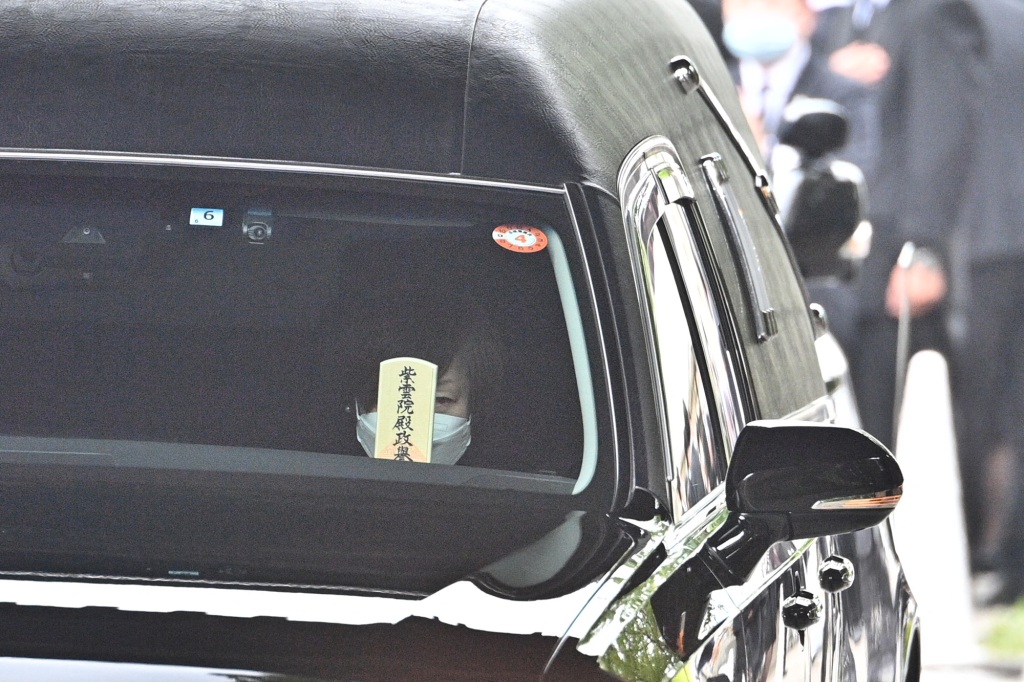Akie Abe, wife of late former Japanese prime minister Shinzo Abe, sits in a hearse as it leaves Zojoji Temple in Tokyo on July 12, 2022.