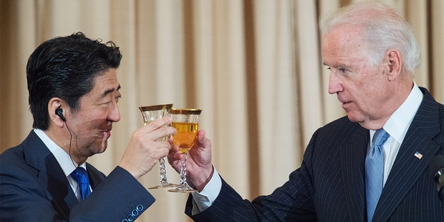 FILE - Vice President Joe Biden toasts Prime Minister of Japan Shinzo Abe as he co-hosts a luncheon with U.S. Secretary John Kerry in honor of Japan on April 28, 2015, at the U.S. Department of State in Washington, DC.  