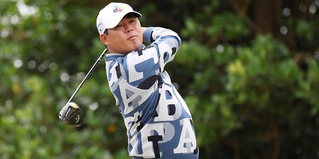 Si Woo Kim of South Korea tees off on the 3rd hole during Day One of The 150th Open at St Andrews Old Course on July 14, 2022, in St Andrews, Scotland. 