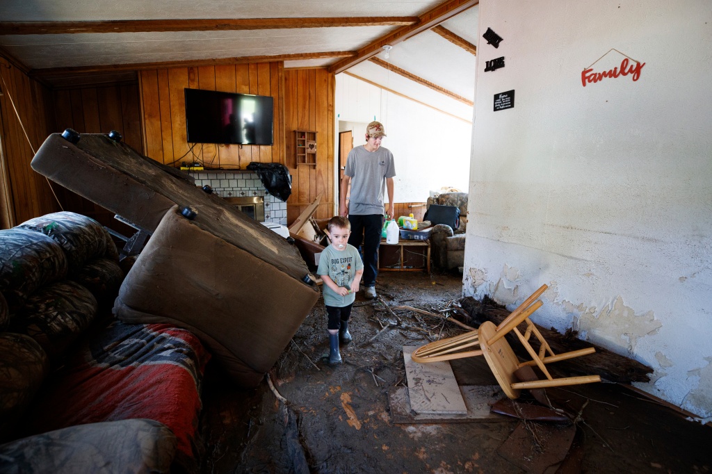 A child walks through his destroyed house, Thursday, July 14, 2022, in Whitewood, Va.