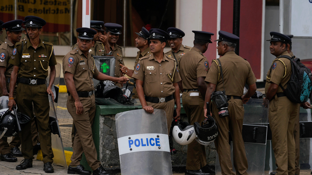 Police officers stand guard outside the official residence of the president in Colombo, Sri Lanka, Thursday, July 21, 2022. 