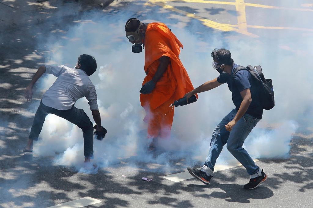 Protesters react after police fire tear gas to disperse them in Colombo, Sri Lanka, on July 9, 2022.