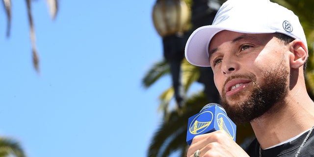 Stephen Curry of the Golden State Warriors speaks to the crowd during the 2022 NBA title parade June 20, 2022, at Chase Center in San Francisco.