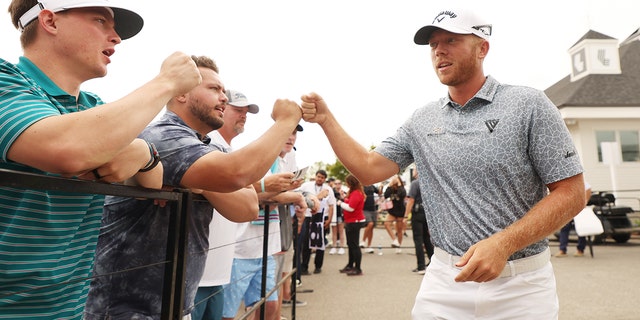 Talor Gooch fist bumps a fan during the LIV Golf Invitational - Portland at Pumpkin Ridge Golf Club on July 2, 2022, in North Plains, Oregon.