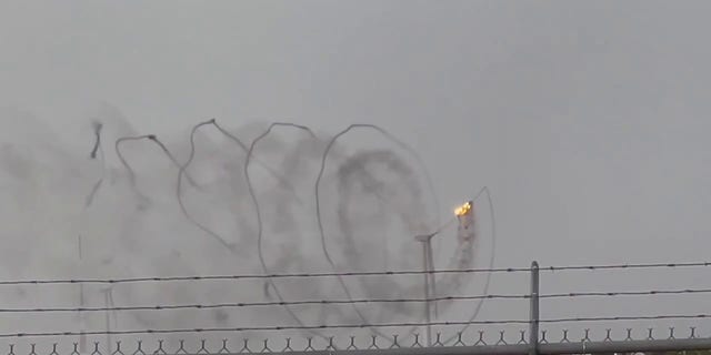 A Texas wind turbine caught on fire after being struck by lightning on Friday, according to video taken by a man who was working in the area.