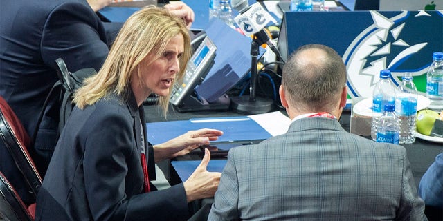 Vancouver Canucks hockey team assistant general manager Cammi Granato, left, takes part in the first round of the NHL draft in Montreal, Thursday, July 7, 2022. At the start of 2022, there were no women serving as assistant general managers in the NHL. Now there are five. Granato hopes this becomes a normal occurrence, and coaching is the next frontier for women in hockey. (Graham Hughes/The Canadian Press via AP, File)