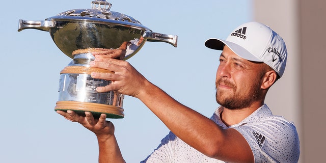 Xander Schauffele holds the trophy after winning the Genesis Scottish Open at The Renaissance Club, North Berwick, Scotland, Sunday July 10, 2022. 