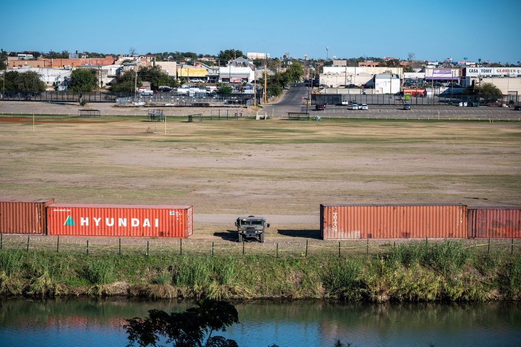Shipping containers line the area near the Rio Grande river on November 19, 2021 in Eagle Pass, Texas.